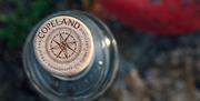 A close up photo of the top of a Copeland Gin bottle with the logo of the Distillery
