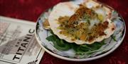 Crumbed scallop presented in scallop shell