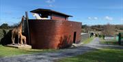 Image of the Ark Open Farm's small replica of Noah's Ark with animal statues including giraffe