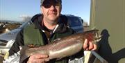 Genteman holding a large fish