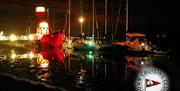 The Lightship lit at night