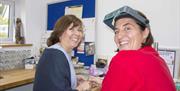 Two happy silver jewellery making women looking towards the camera smiling