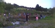 People walking around the edge of the water
