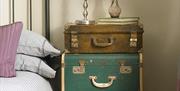 Decorative suitcases at bedside