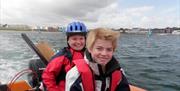 a photo of two people on a boat