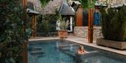 Blonde female in outdoor hot pool