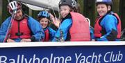 a photo of 4 people in lifejackets