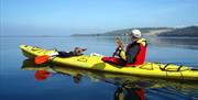 image of a young boy and a man in canoe out on the water
