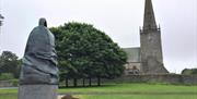 Statue of The Bangor Bell outside of Bangor Abbey in the city
