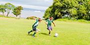 Two pupils playing football