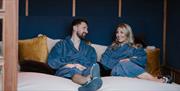 A couple relaxing in dressing gowns