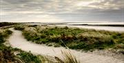 Photo of beautiful Cloughey beach and boardwalk