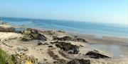 photo of the beach showing the sand and the sea