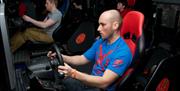 A man using the Race-2-Drive game