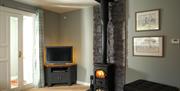 Living room area with tv and stove