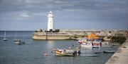 Image of Donaghadee lighthouse and boats tied in the harbour