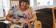 Christine Casey of Kiri Cottage Crafts, spinnging