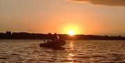 A rib on the water at sunset
