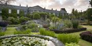 Photo of the formal gardens in colourful bloom at Mount Stewart with the Estate House in the background
