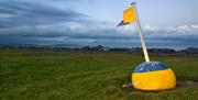 Photo of flagged bouy set out as decor at Ballyholme near the pitch and putt facility, overlooking the bay