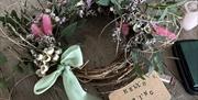 A picture of the wreath with some stunning voile ribbon