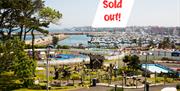 Photo taken on a summers day with a view over Pickie Funpark and the marina with the words 'sold out'