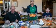 Tracey serving up pizza, tea and more treats to her paddle boarding guests