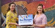 Members of music acts Soda Popz and the Leading Ladies Trio promote Sea Bangor on Eisenhower Pier