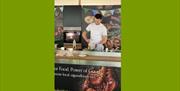 Image of a chef behind demo kitchen prepping food