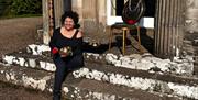 Tessa Ann outside Temple of the Winds with sound instruments