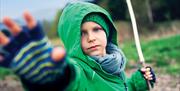 Child casting a spell with a willow wand