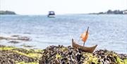 Model Viking boat on shore