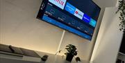 TV Unit showing smart tv and bookcase with back lighting