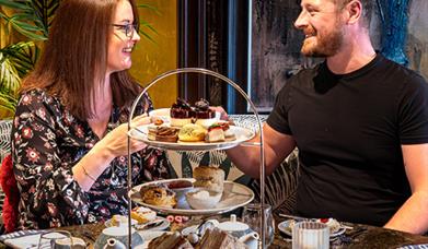 Two people enjoying afternoon tea