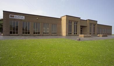 Photo of museum exterior and grassland to front