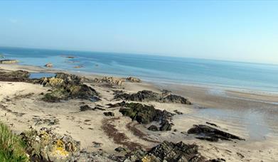 photo of the beach showing the sand and the sea