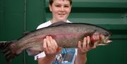A boy holding a large fish