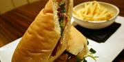 A close up image of a baguette meal with fries