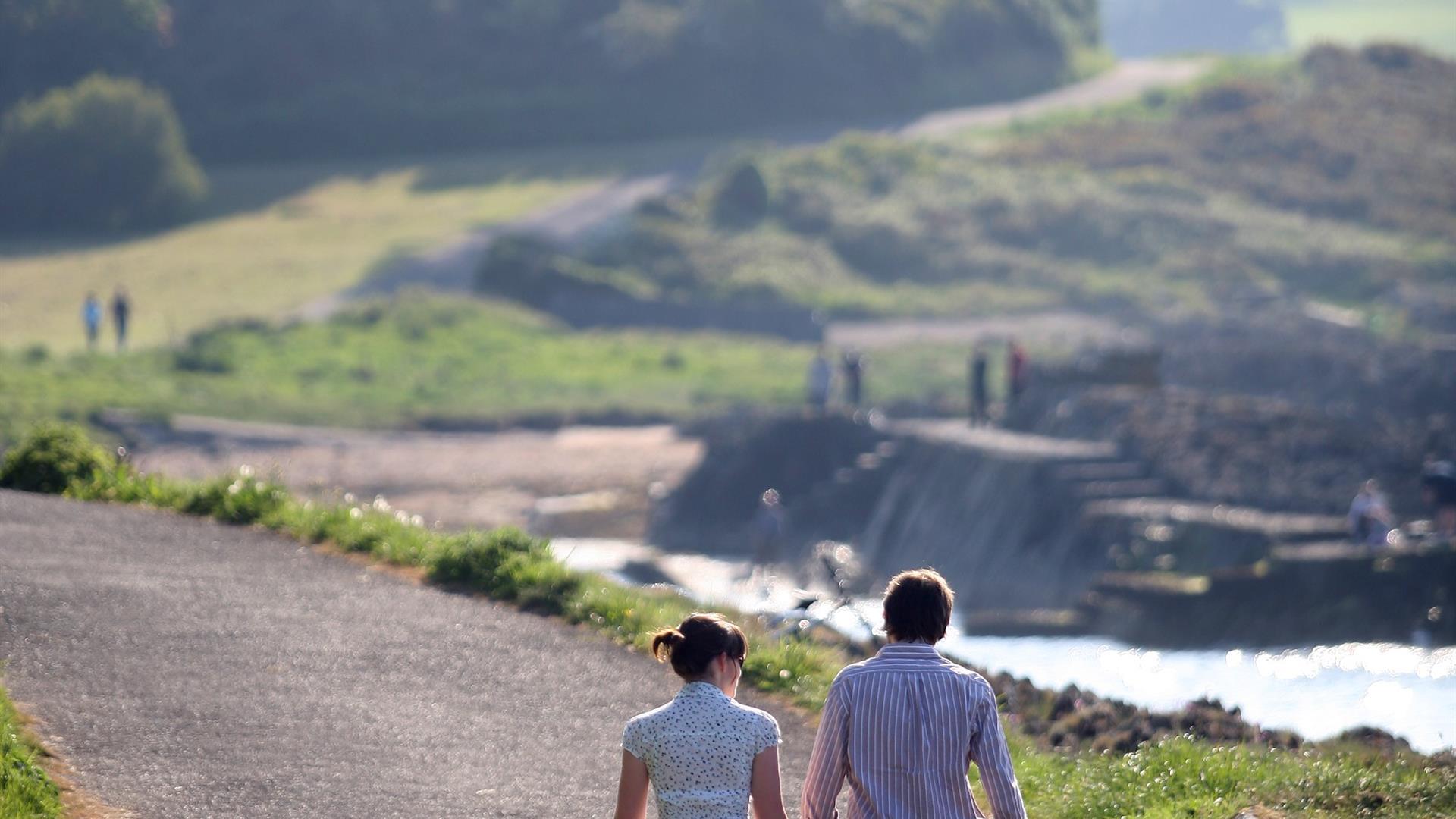 A couple walking along the North Down Coastal Path