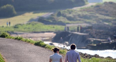 A couple walking along the North Down Coastal Path