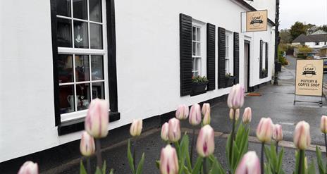 Front exterior to cafe with Tulips in the forefront