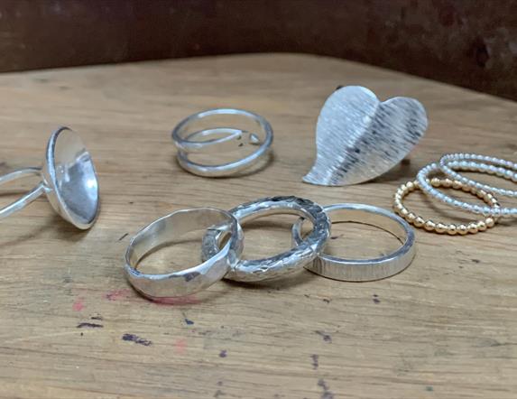 a photo of a selection of silver rings on a table