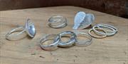 a photo of a selection of silver rings on a table