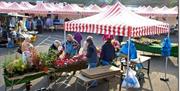 Photo of a selection of red and white striped stall gazebos of Bangor Market