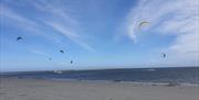 Kite surfers on the water and in the air