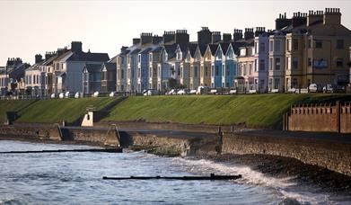 Ballyholme Esplanade during the day showing the waters splashing against the seawall.