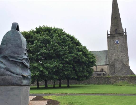 Statue of The Bangor Bell outside of Bangor Abbey in the city
