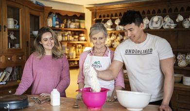 couple in kitchen with Tracey making bread.