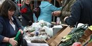 Photo of a busy vegetable stall in the market