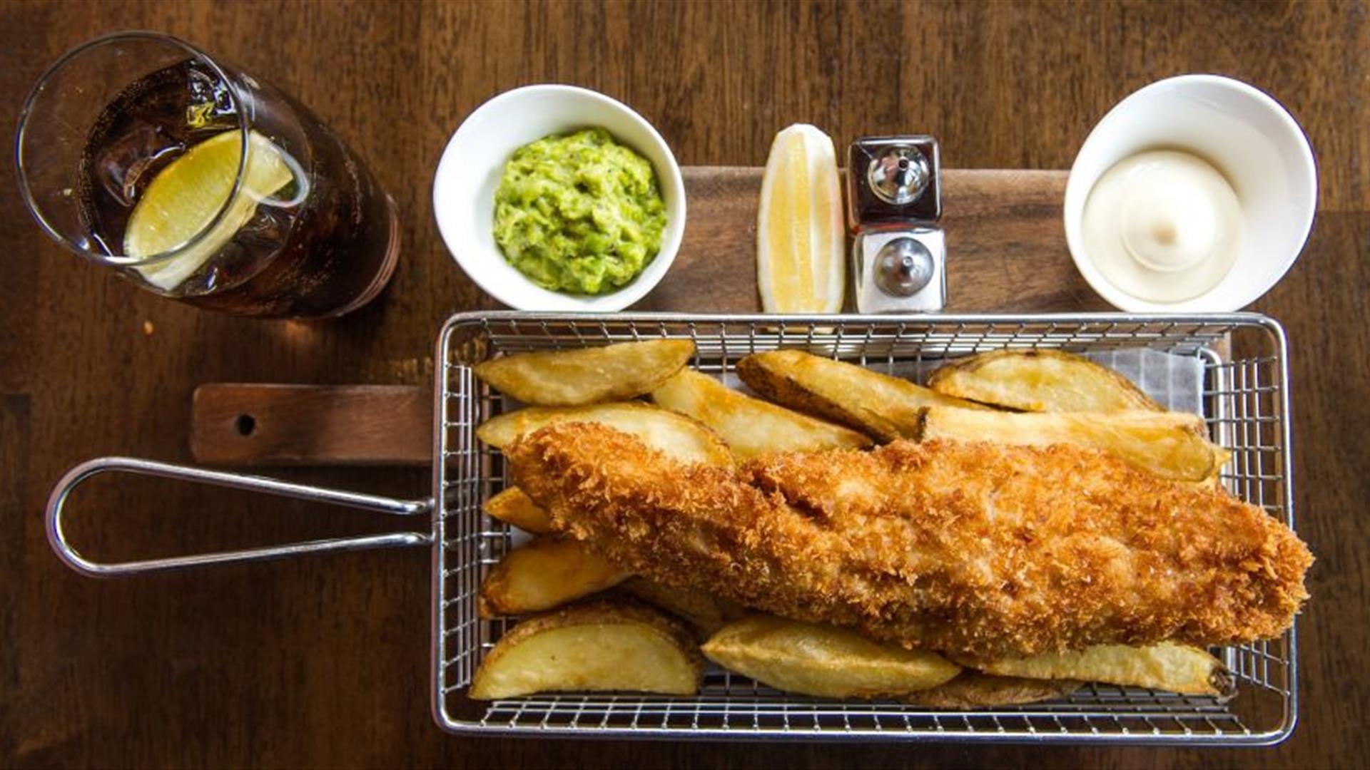 Fish and Chips in basket with accompaniments